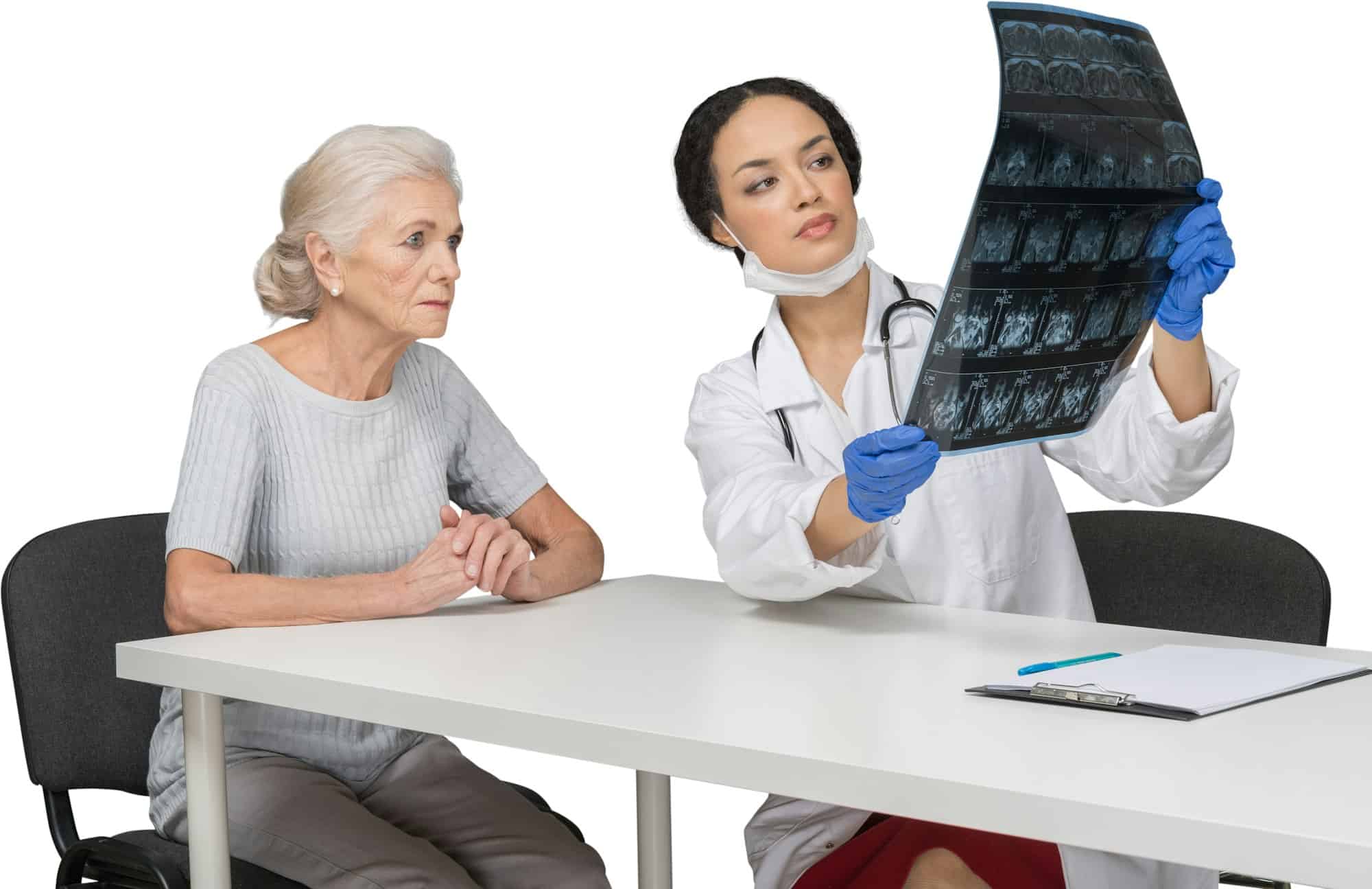 a doctor showing a mammogram to an older woman sitting at a table