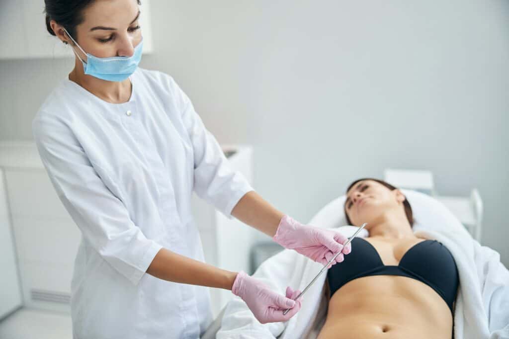 Doctor performing a skin biopsy in a patient