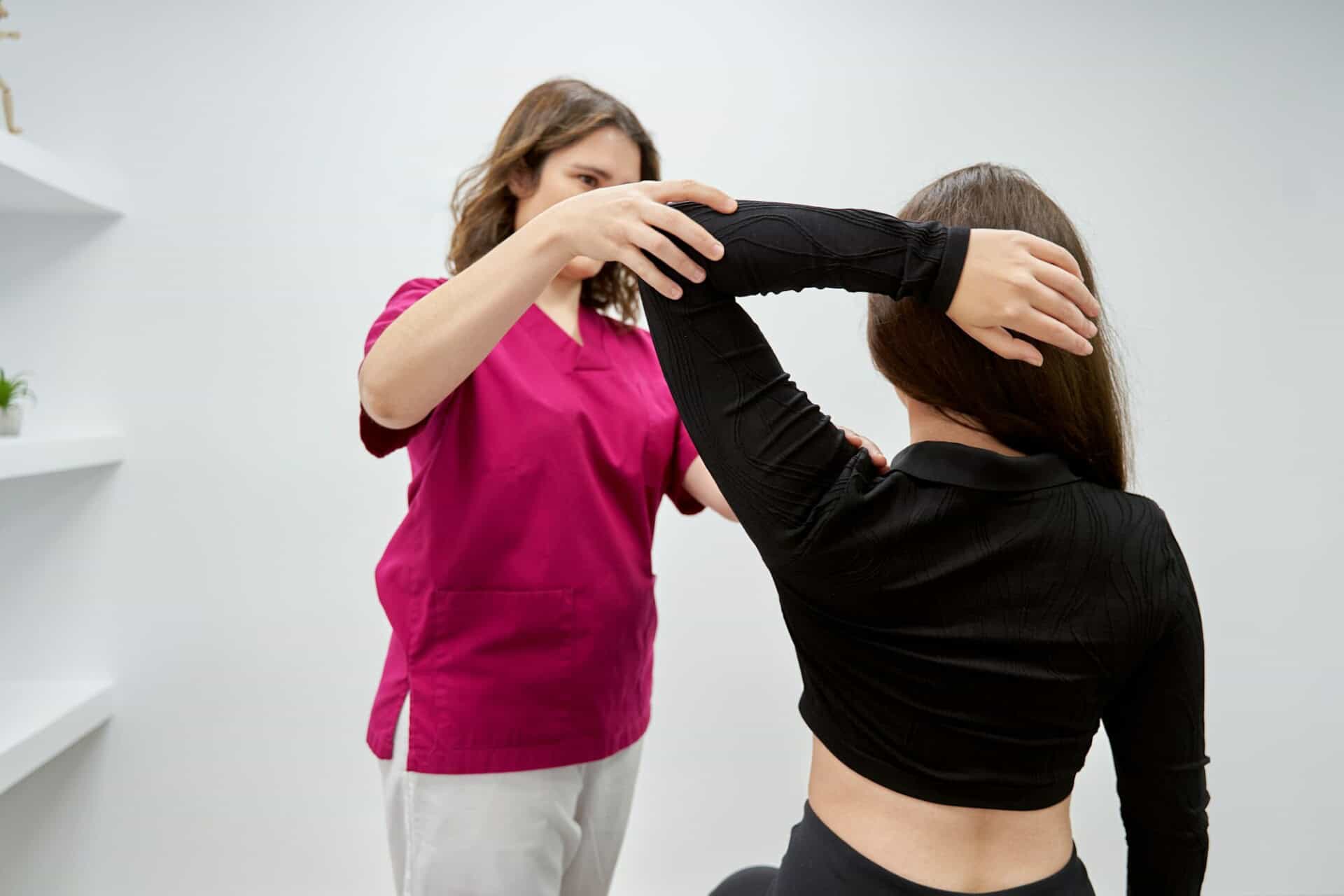 Physiotherapist examining a patient during a consultation in a medical center.