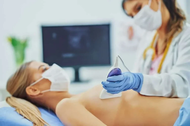 Doctor performing breast ultrasound